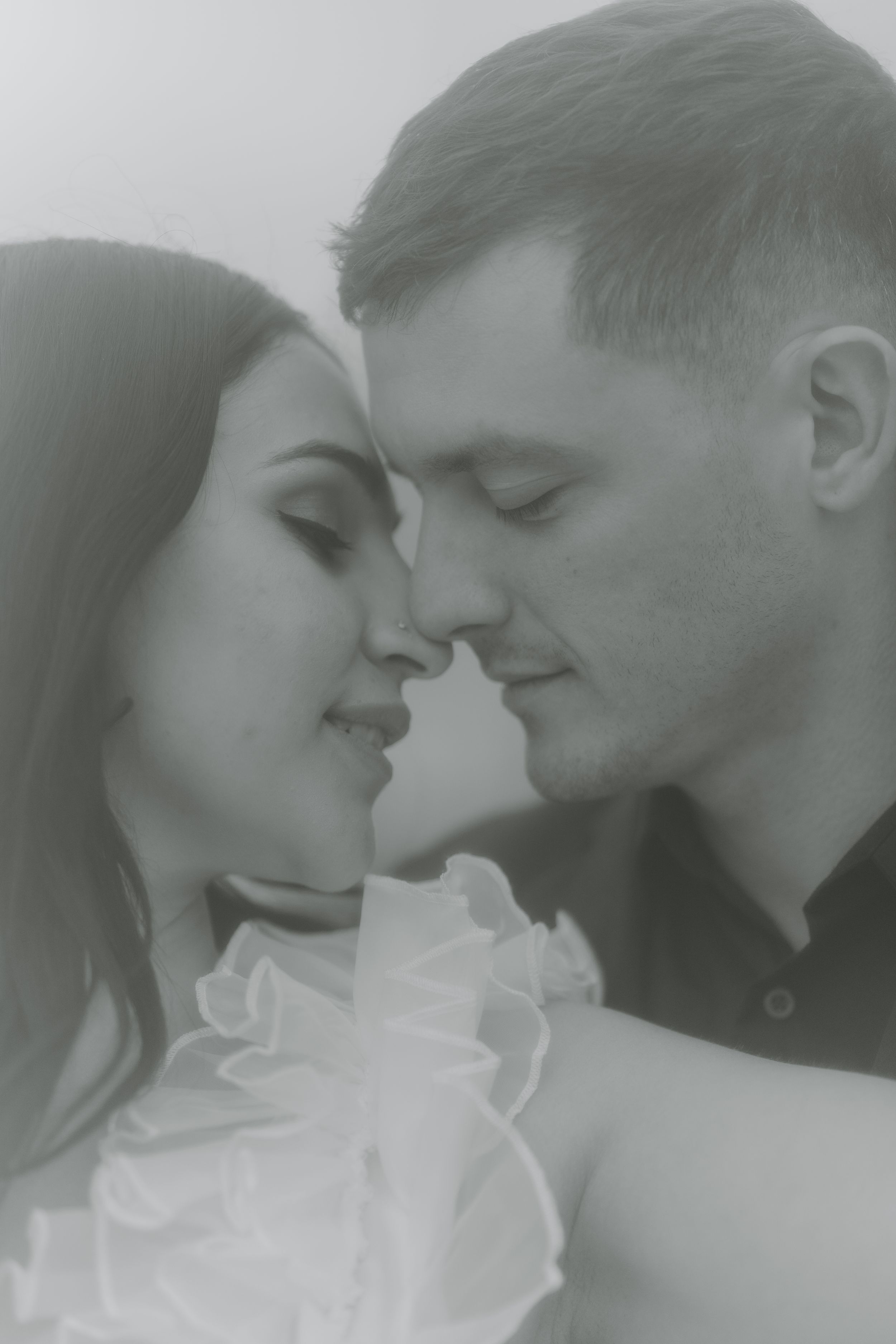 A romantic black and white photo sequence showing a couple sharing an intimate kiss.