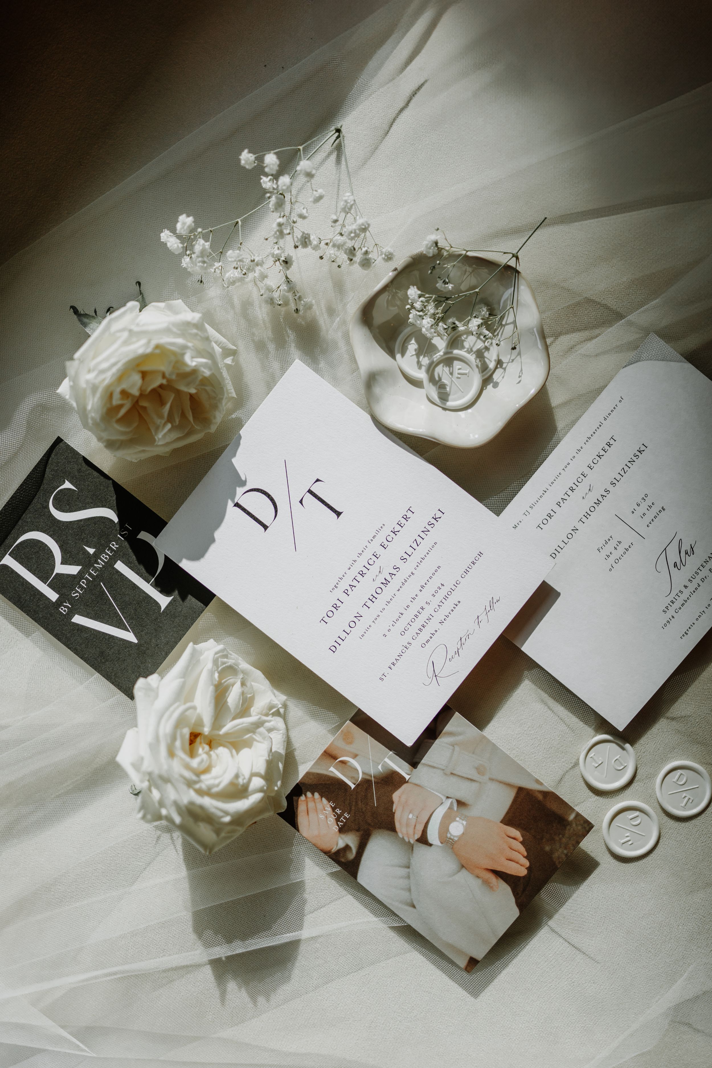 Wedding invitations and stationery styled with white roses and delicate details.