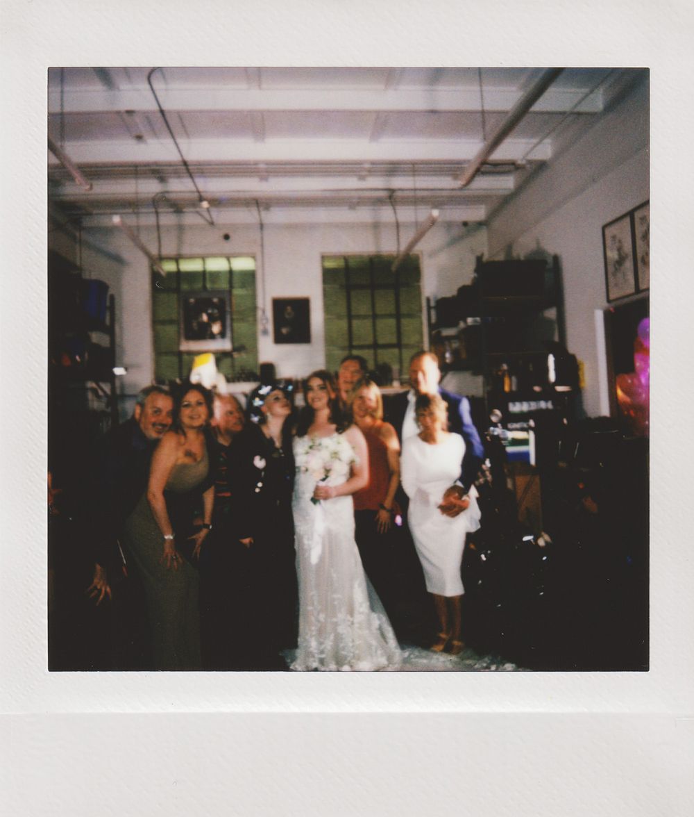 Group photo in an industrial-style venue with exposed ceiling and windows.