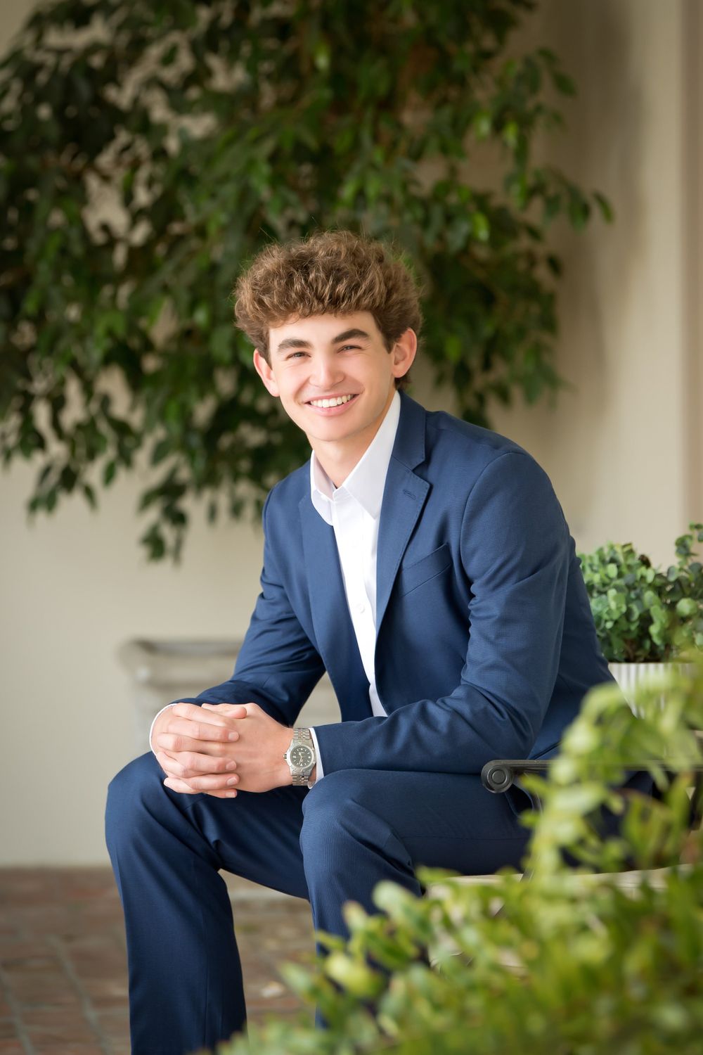 Multiple angles of a casual portrait session on a porch with columns and greenery.