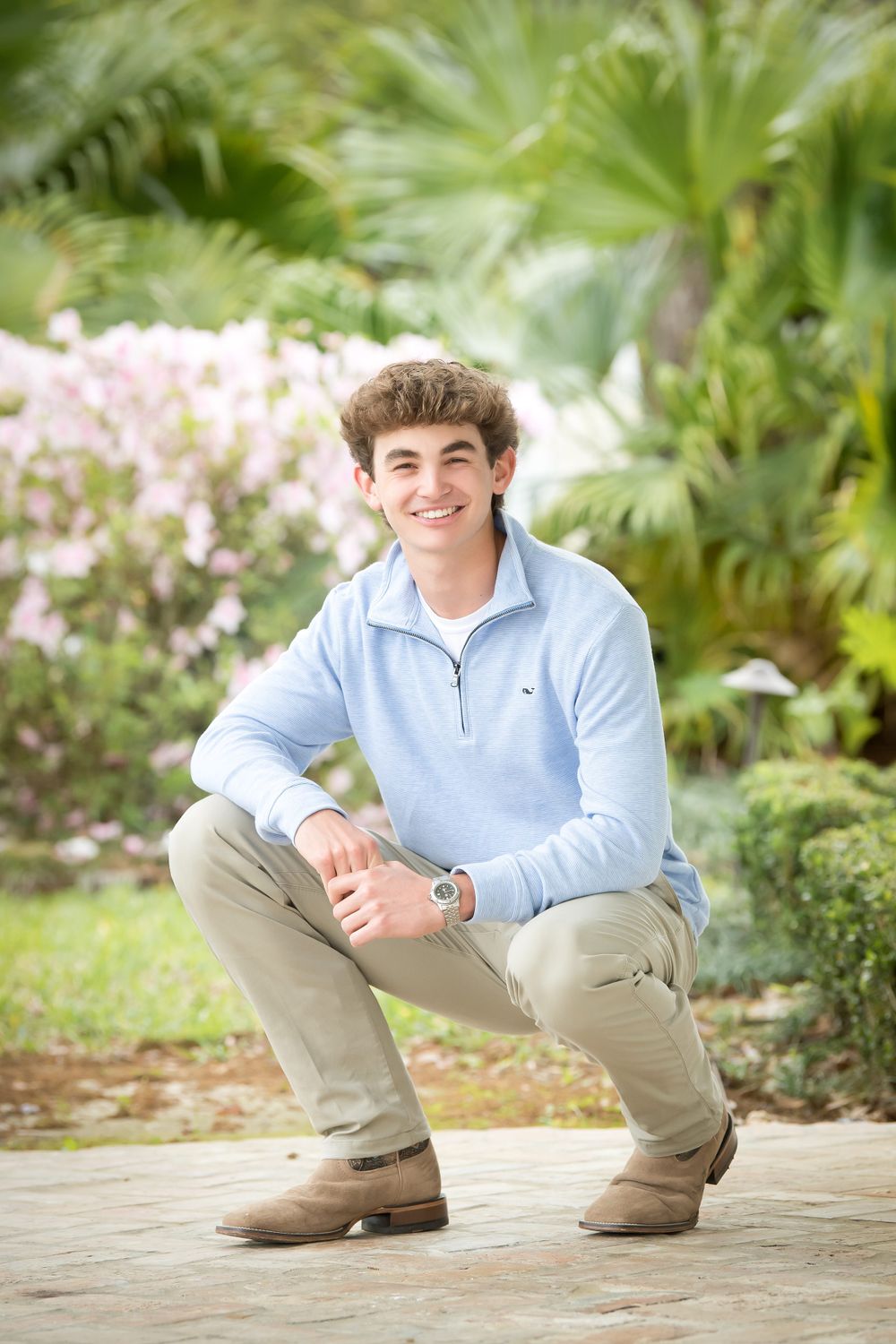 Casual outdoor photo session featuring poses against a lush tropical garden backdrop.