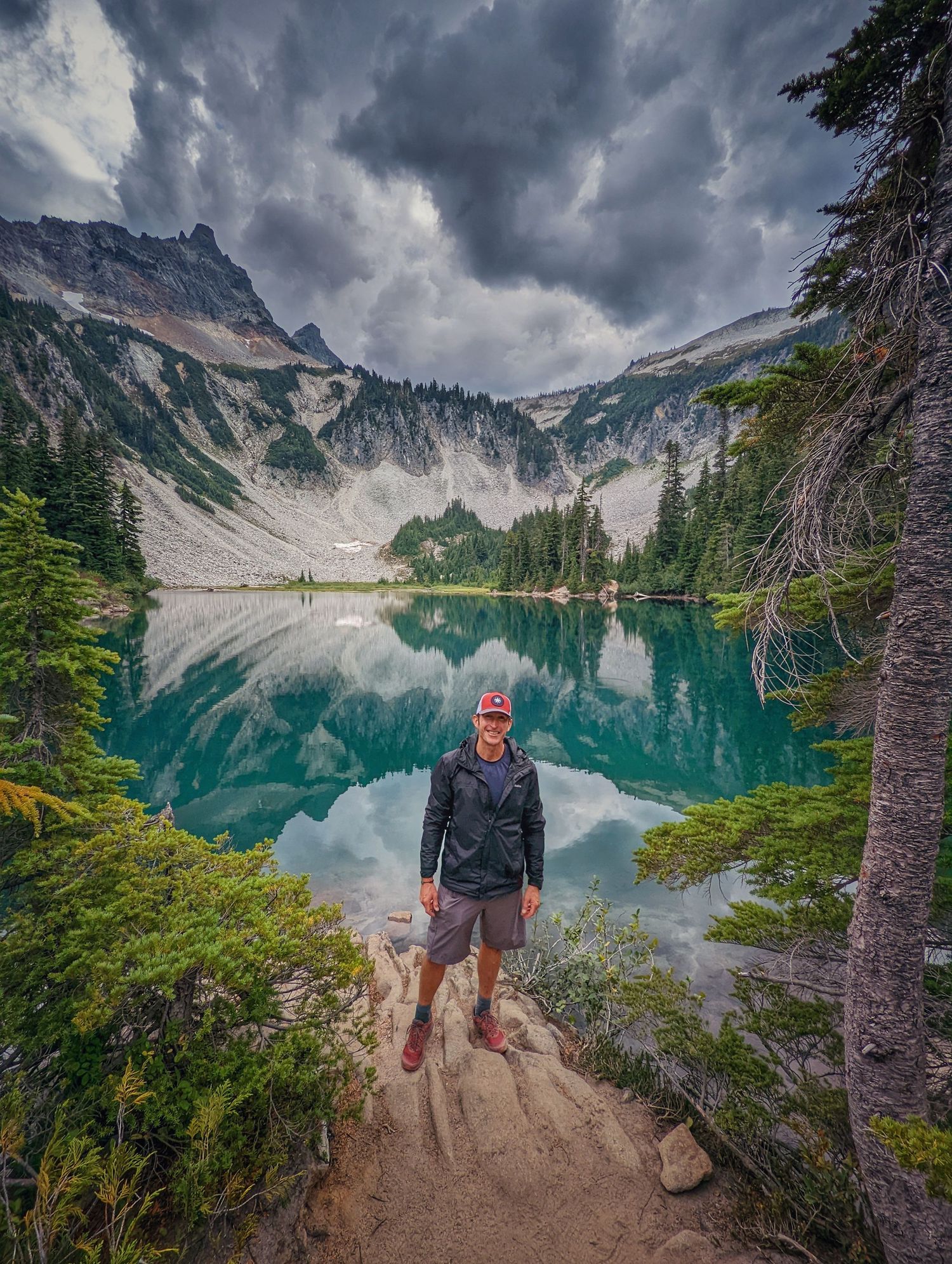 A picture of me by a beautiful lake.