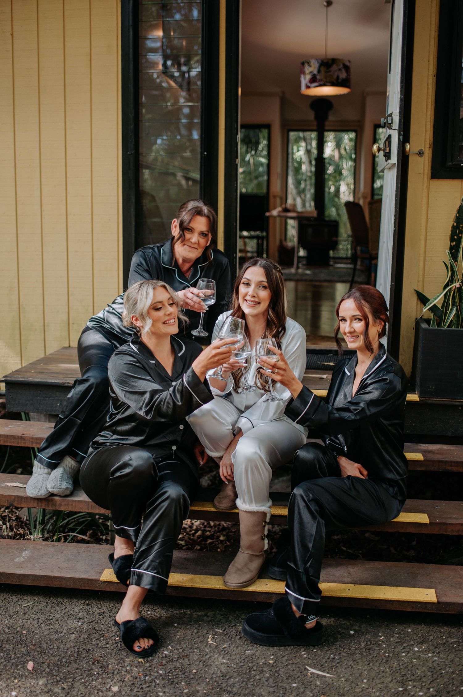 A casual gathering on outdoor steps with drinks and laughter.