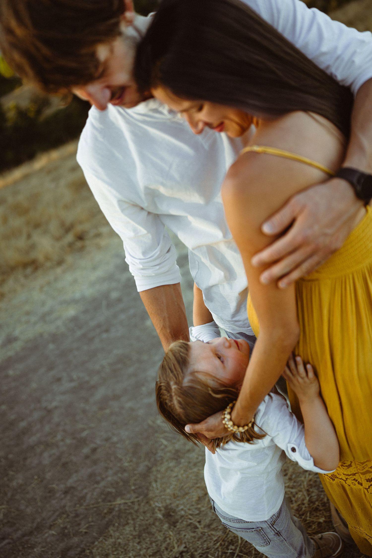 Close-up shots of tender family interactions during an outdoor photo session.