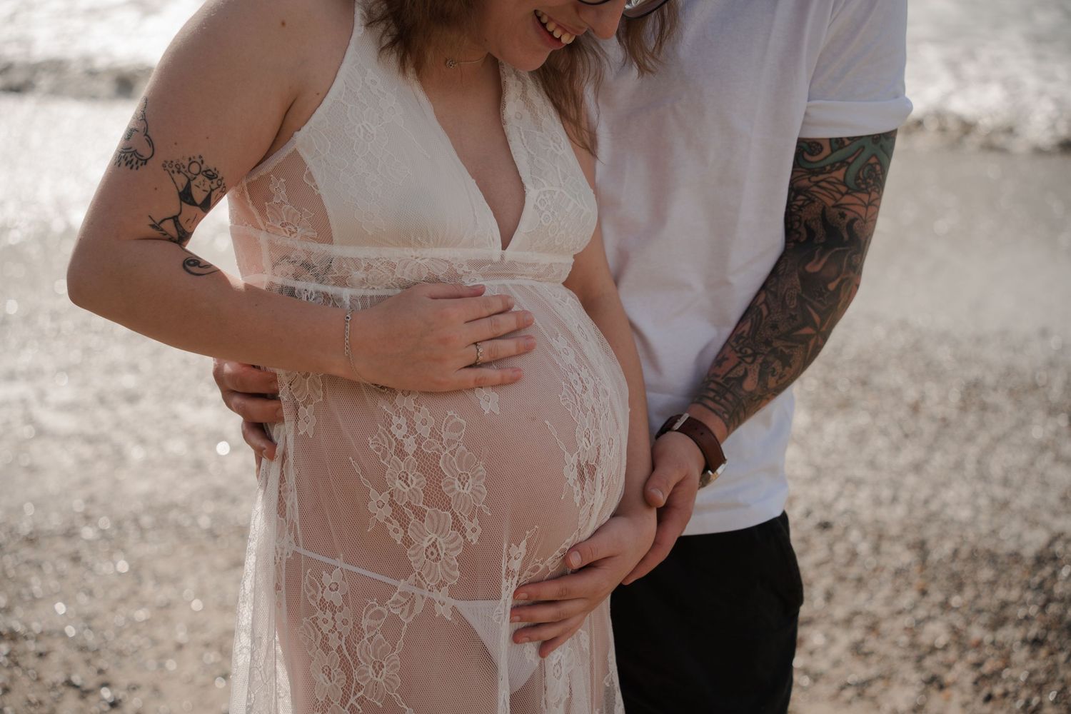 Father and mother holding expecting mothers belly