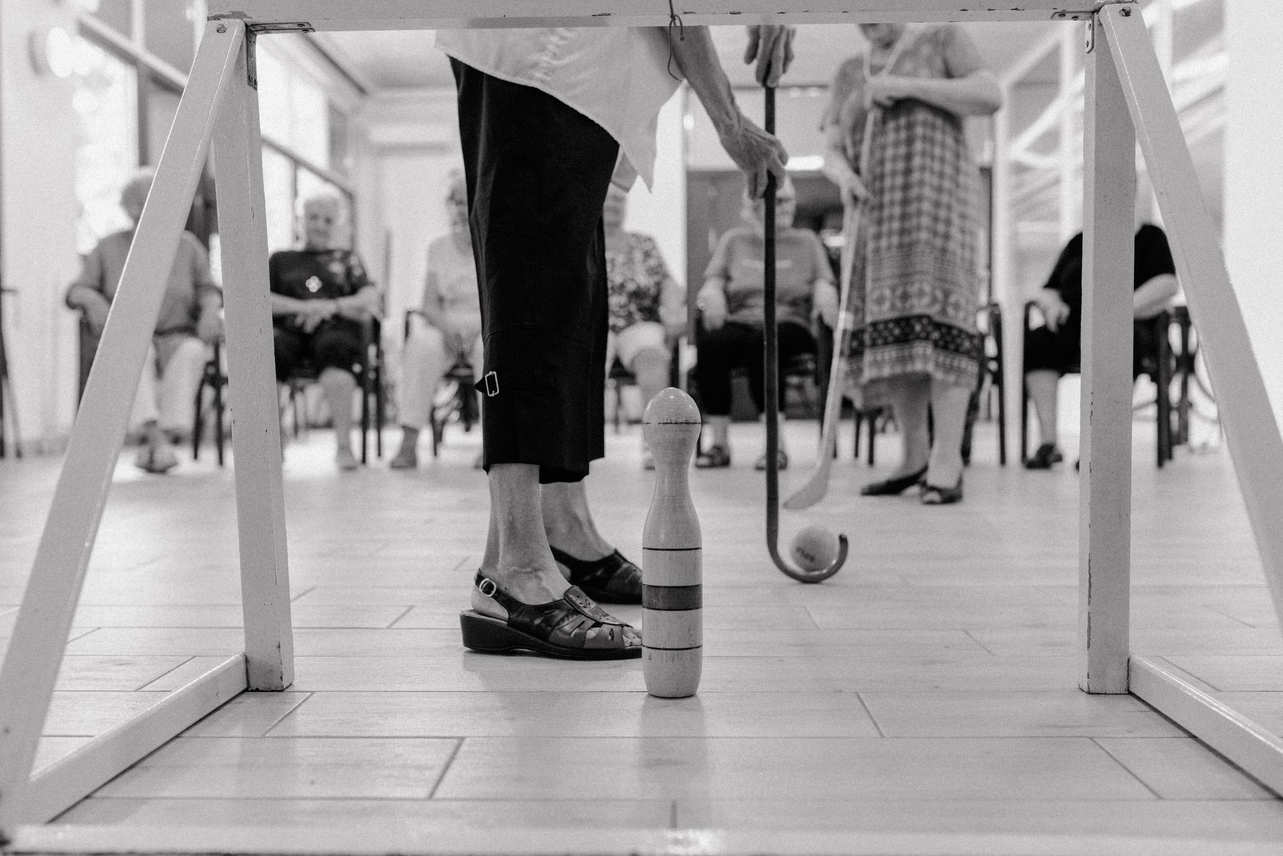 Elderly women enjoying a game inside the senior home, captured in brand photography style.