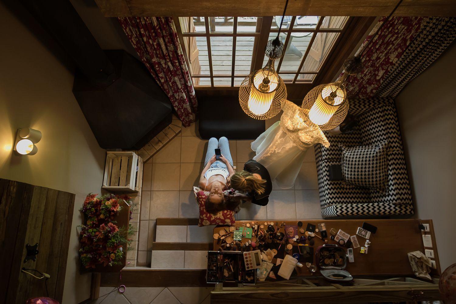 An artistic overhead shot of a wedding venue interior with hanging lights and decorative elements.