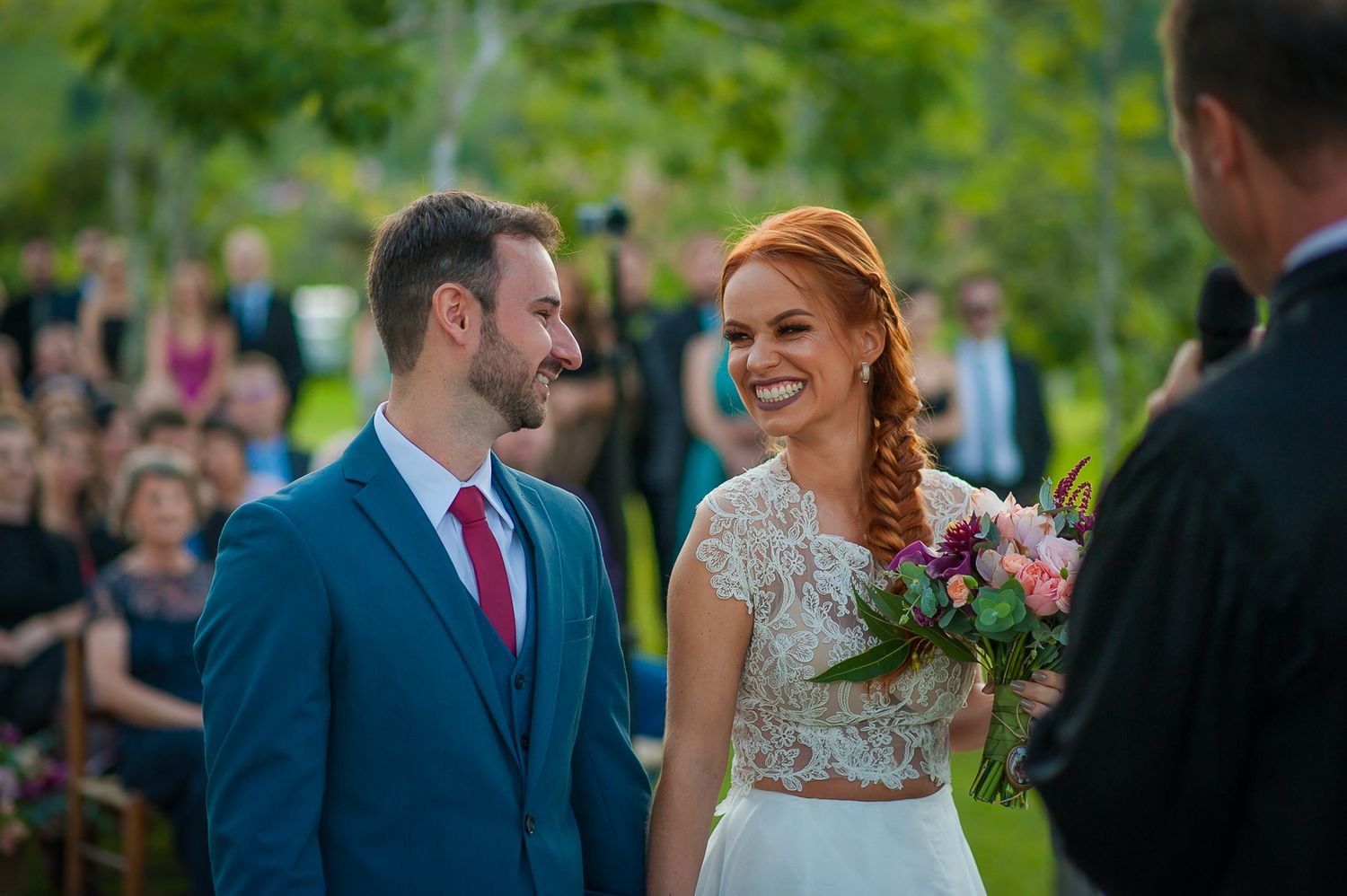 Wedding ceremony taking place in a lush garden setting with natural lighting.