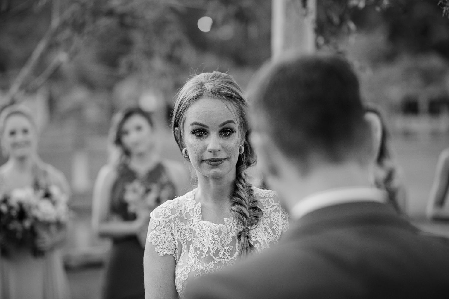 Black and white portrait during outdoor wedding ceremony.