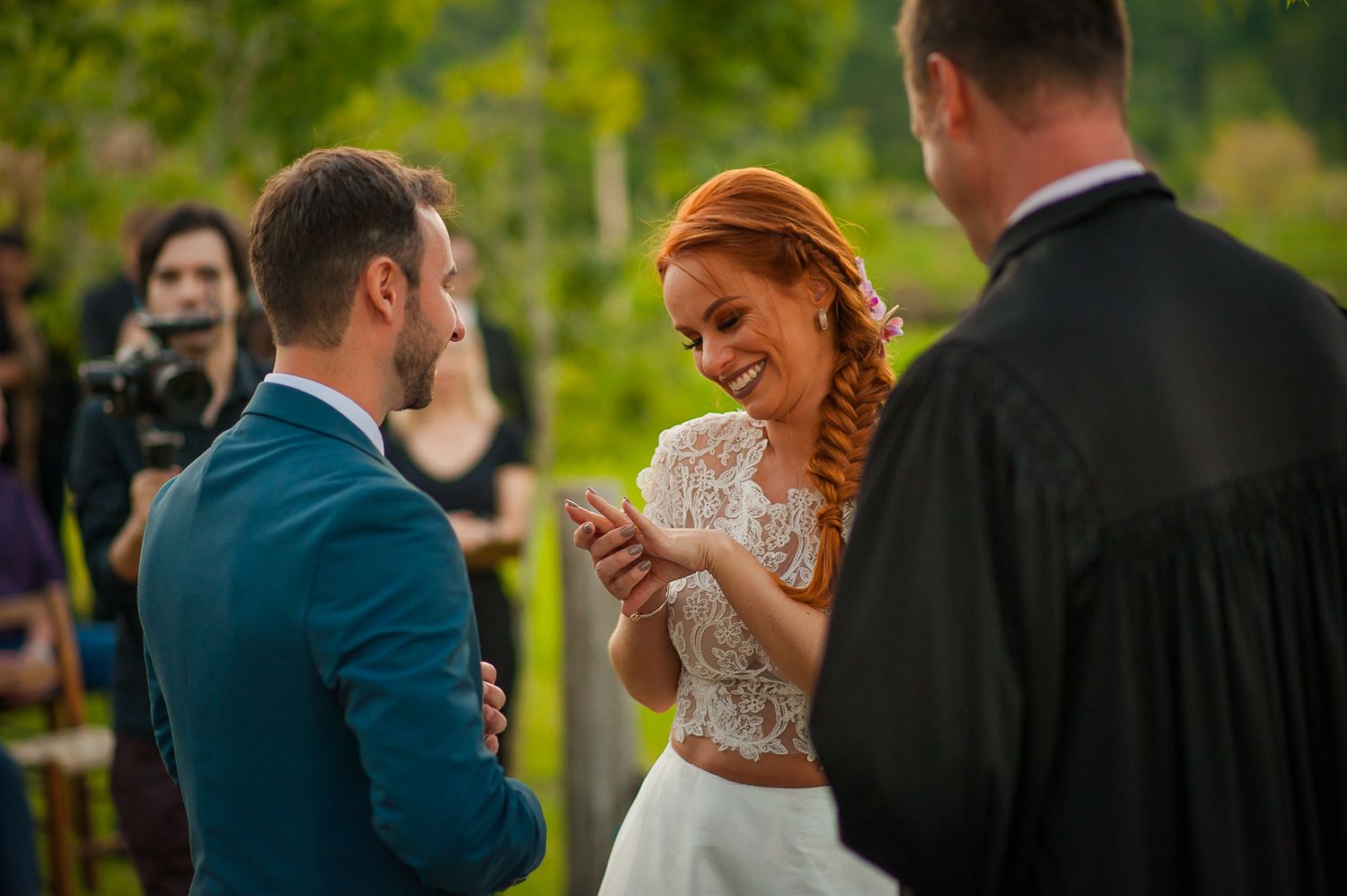 A joyful wedding moment as the couple reads their vows during an outdoor ceremony.