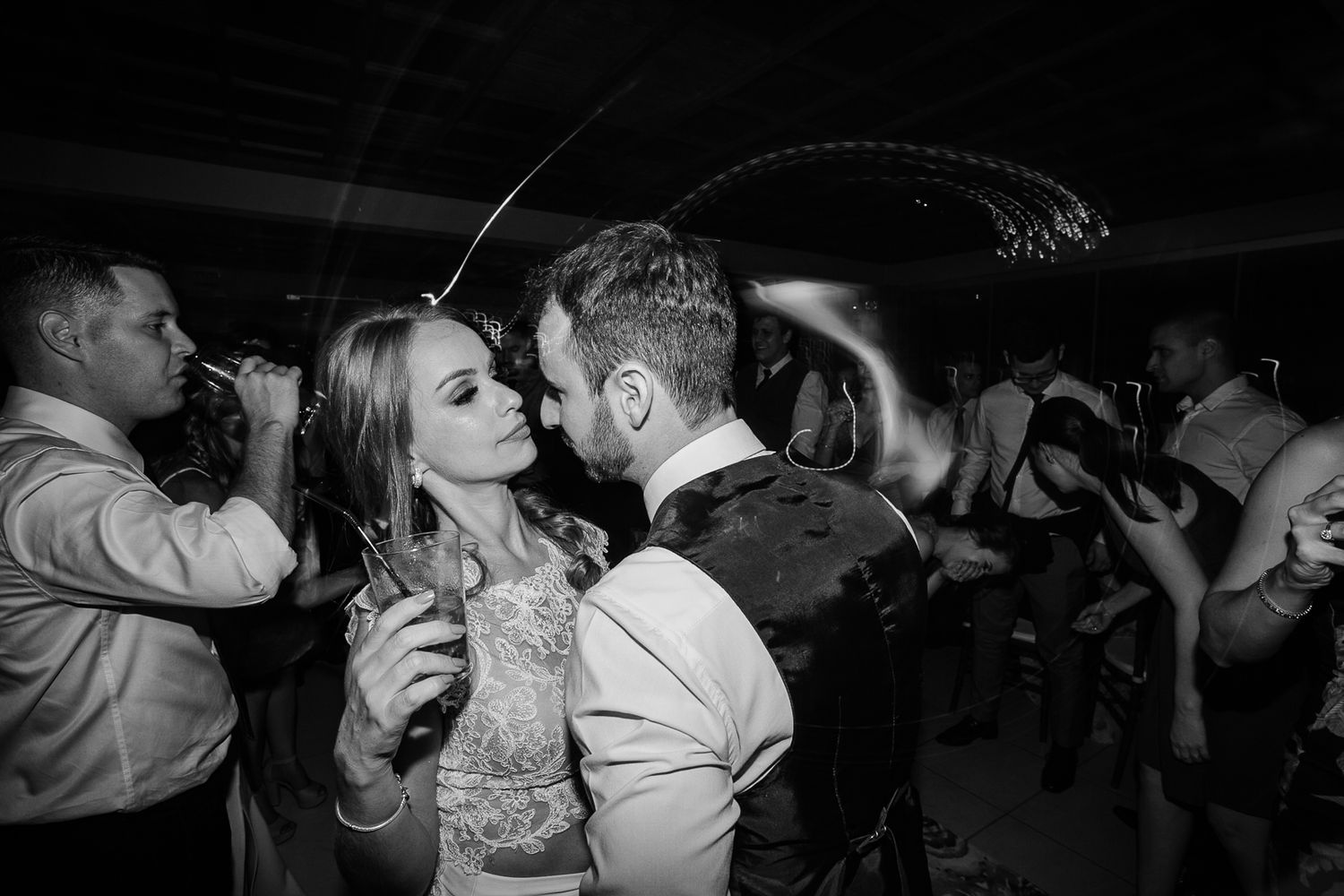 Intimate dance floor moment captured in dramatic black and white photography.