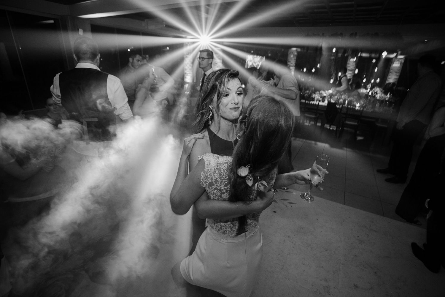 Dramatic lighting and fog effects create atmosphere on the dance floor.