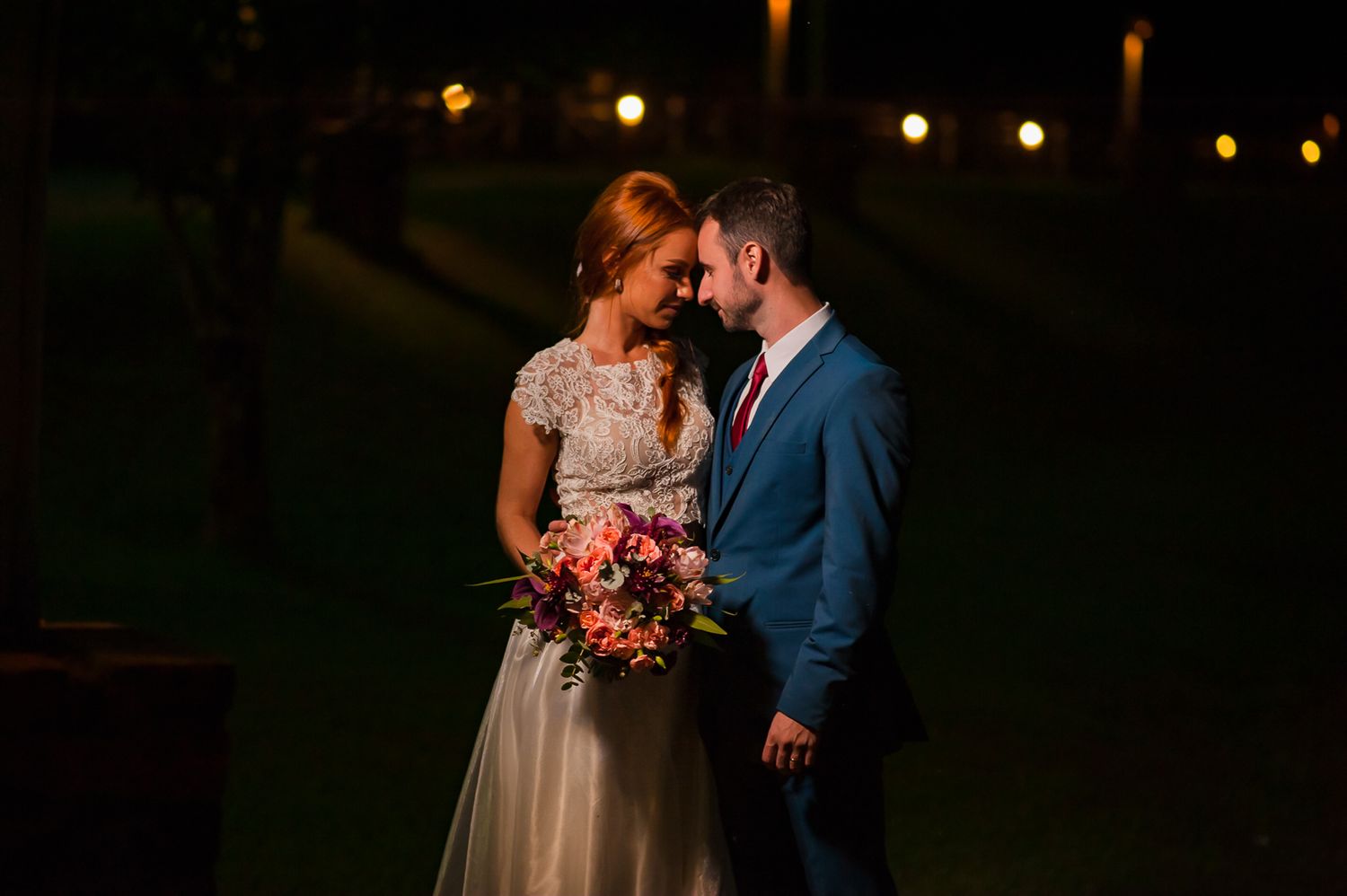 An intimate nighttime moment with a romantic bouquet of pink flowers.