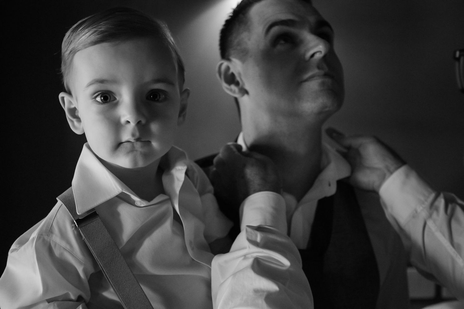 An intimate black and white portrait shows a tender moment between two people.