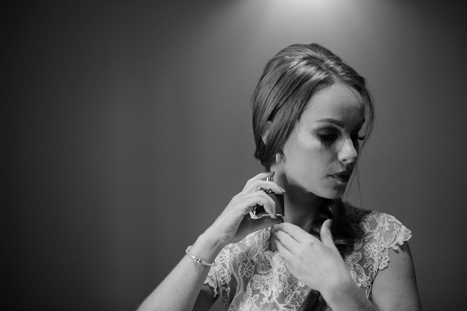 Dramatic black and white portrait showing fine details of lace bridal gown.
