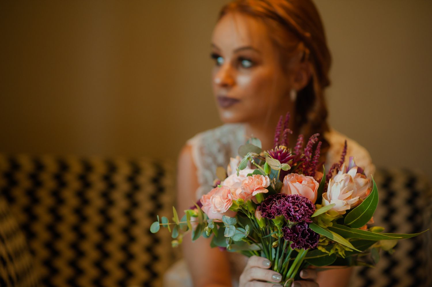 Soft focus portrait with bouquet featuring pink roses and purple flowers.