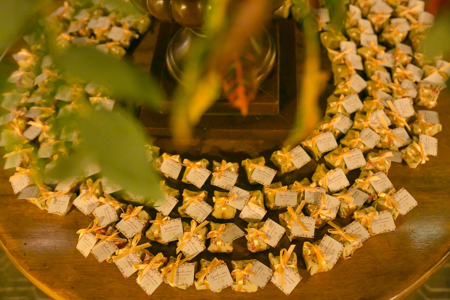 Decorative display of wedding place cards arranged in a curved pattern on a wooden table.