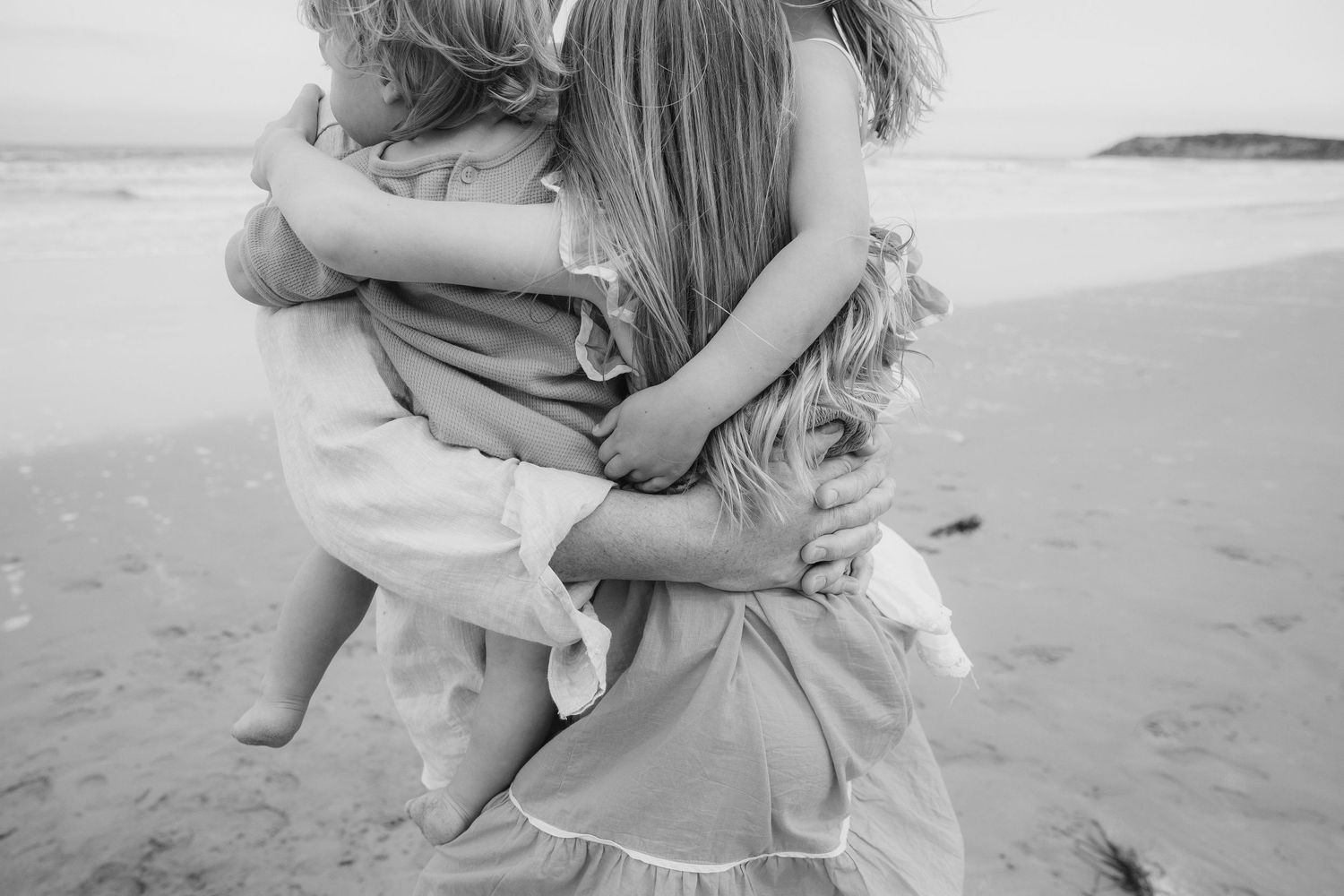 Dad holding all 3 kids in his arms, everyones arms and bodies tangled together, Ocean Grove