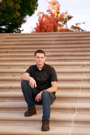 Portrait series on concrete steps with autumn scenery in background.