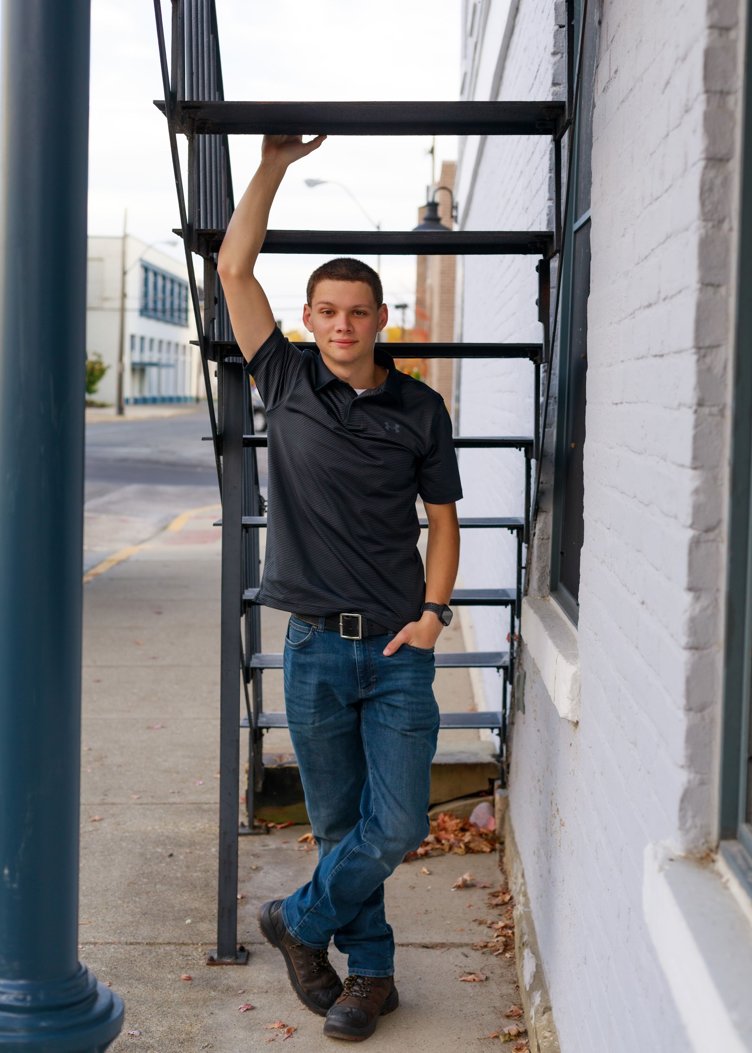 Urban architectural photo shoot with black metal railings and white columns.