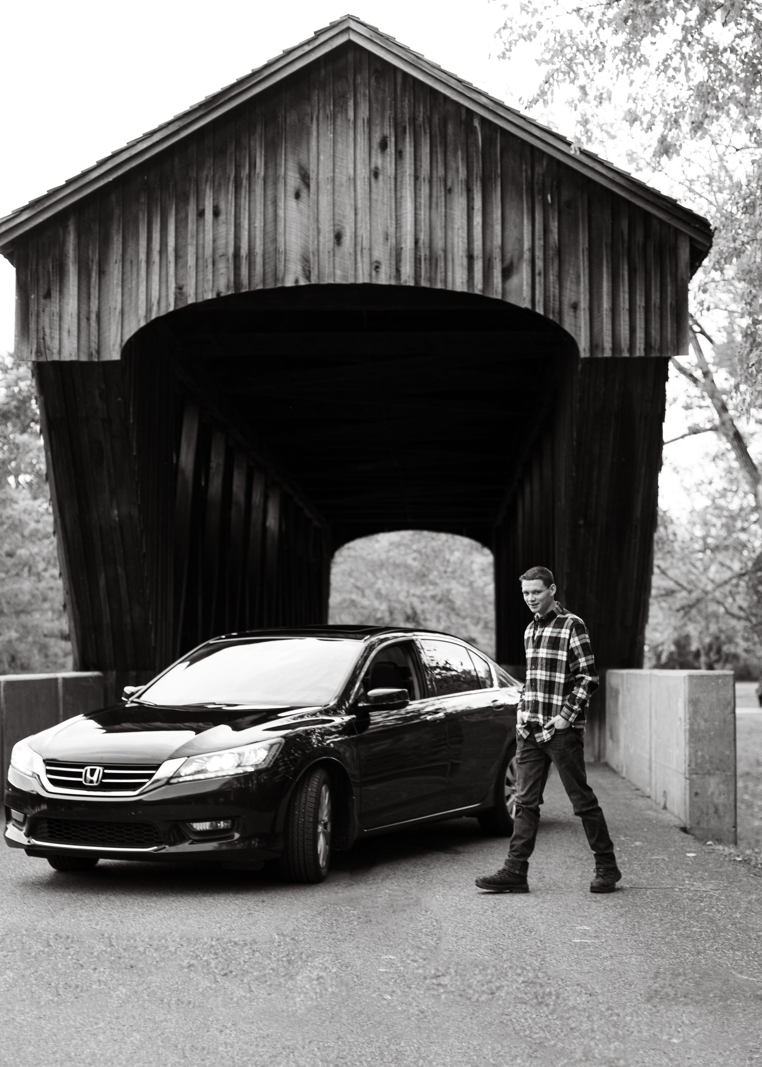 Black and white photo series showing person and car near covered wooden bridge.