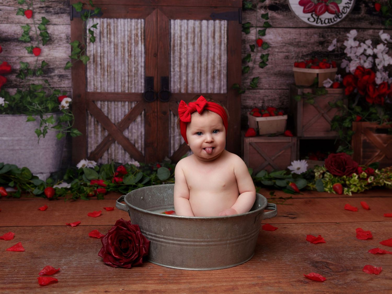 Rustic bath photography setup with galvanized tub and scattered rose petals.