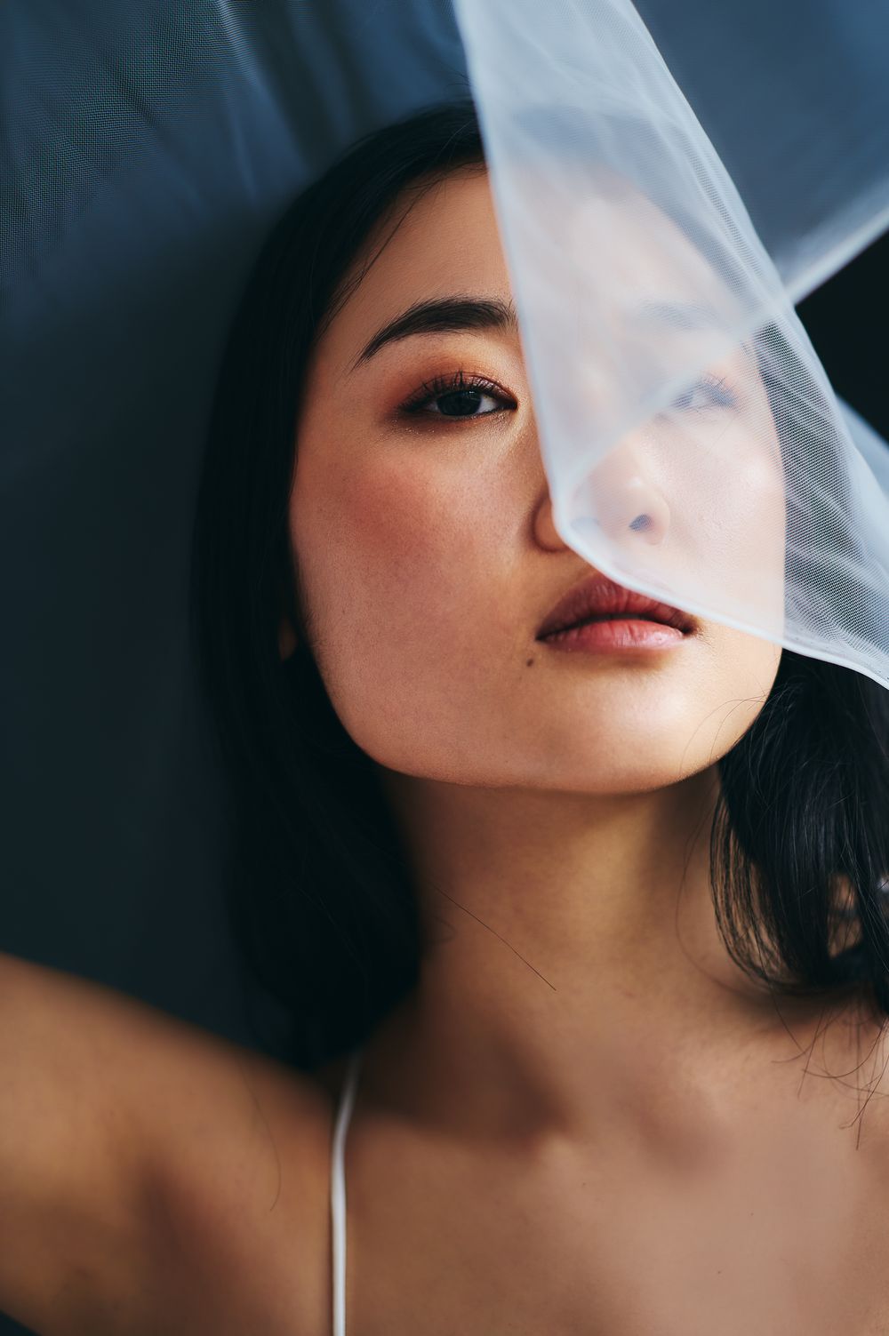 Artistic portrait series showing smoke drifting across a person's face with red lipstick against dark background.