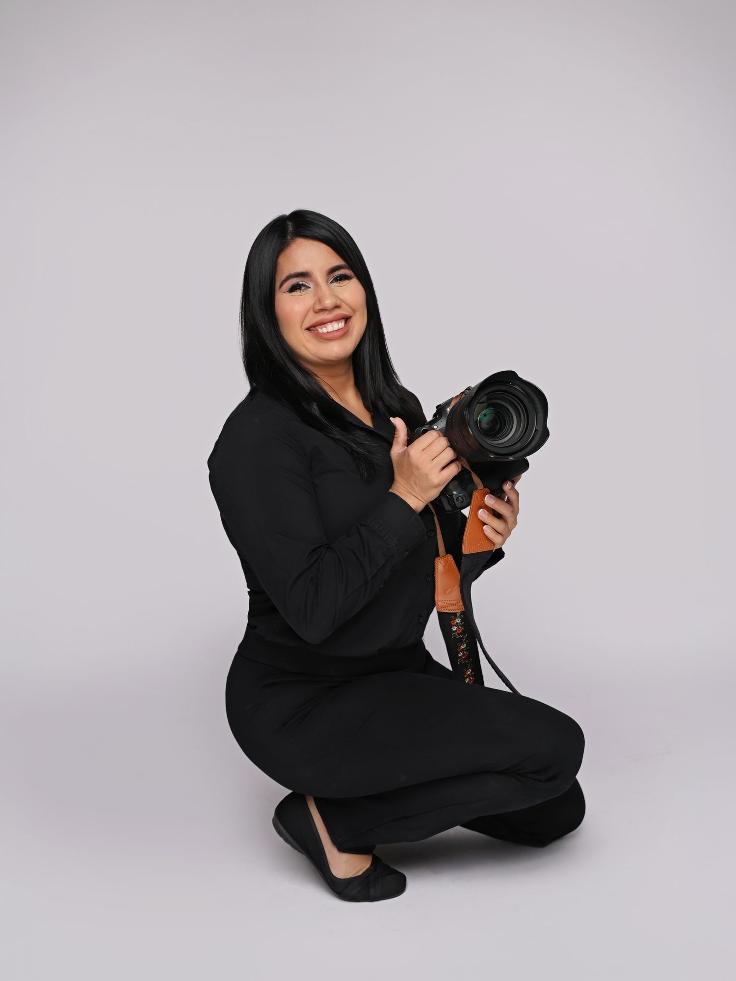 Professional camera setup with flash and trigger mounted for studio photography.