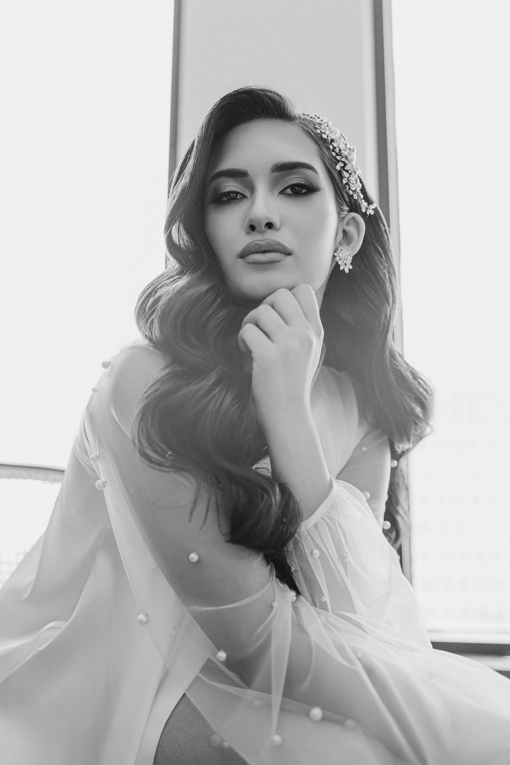 Classic black and white bridal portrait with crystal headpiece and flowing waves.