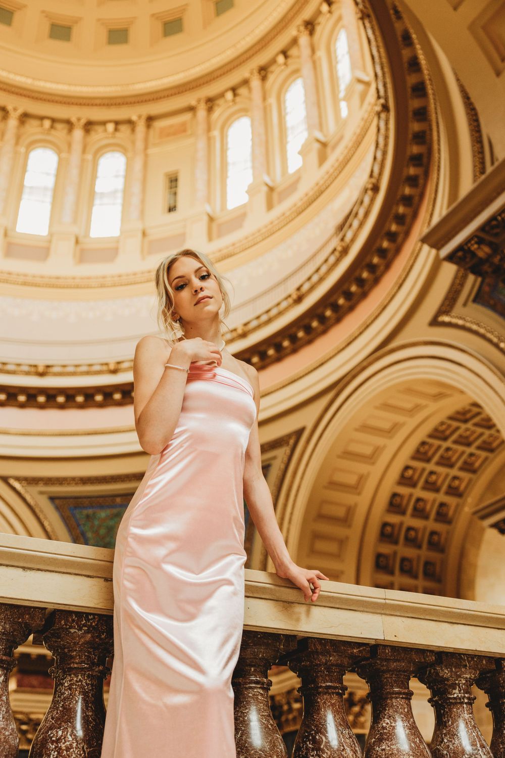Fashion portraits captured under an elaborate domed ceiling with classical details.