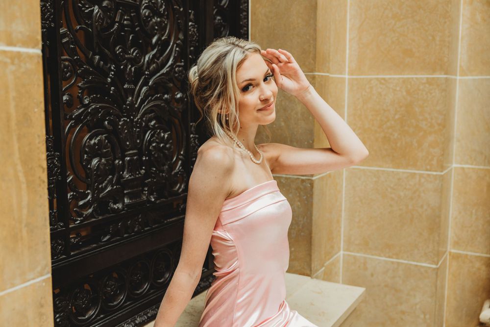 Artistic fashion series against textured stone walls in natural lighting.