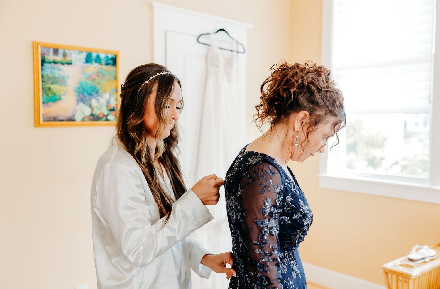 A series of photos showing wedding day preparation with someone getting their hair and makeup done in a bright room.