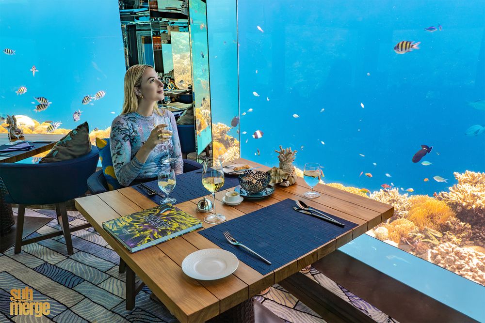 Underwater restaurant with panoramic views of coral reef and tropical fish in the Maldives.