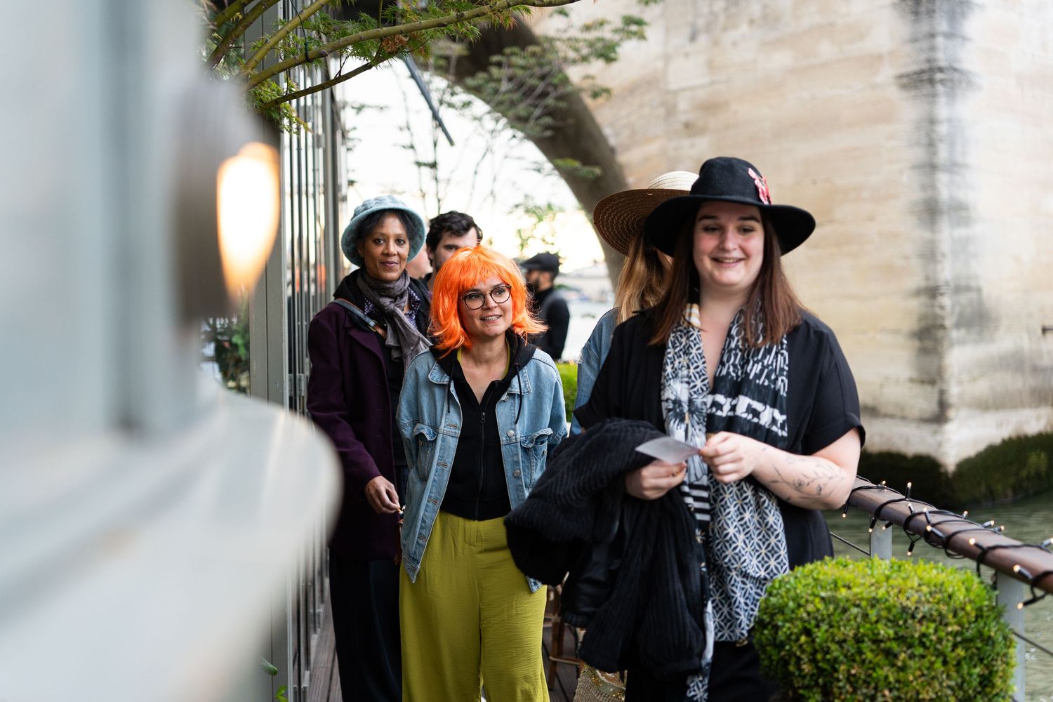 Group wearing casual attire walking together outdoors on a sunny day.