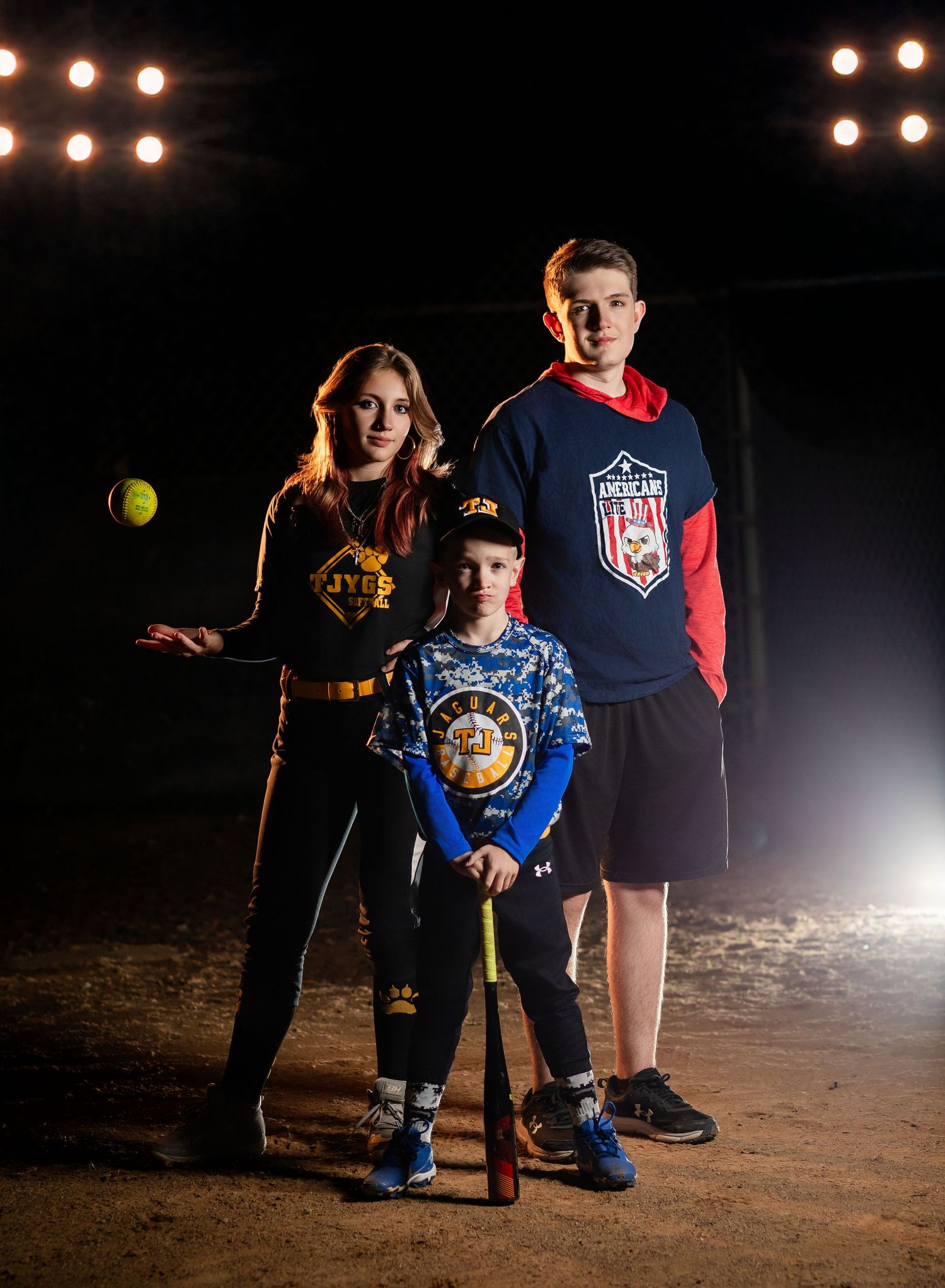 Dramatic sports portrait with smoke effects and chain link fence background.