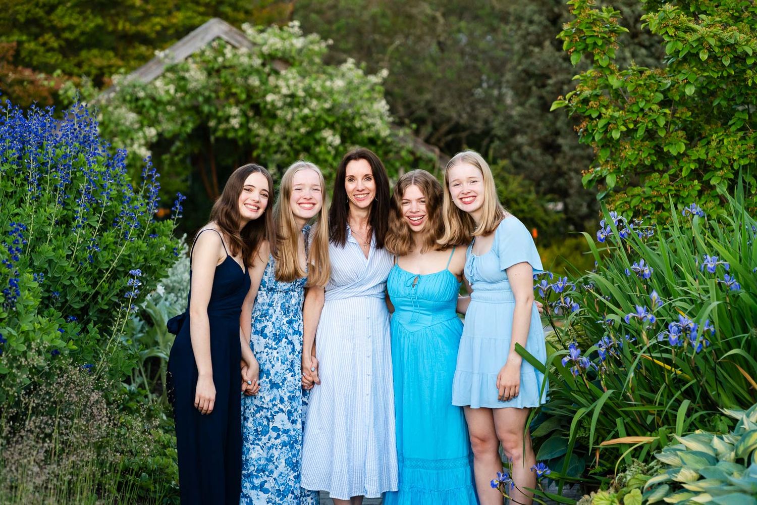 Mother and daughters pose for portrait in a garden in Seattle.