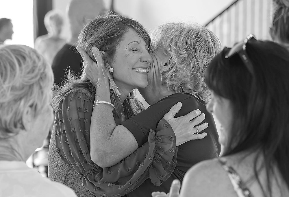 Black and white candid shots of friends sharing joyful moments together.