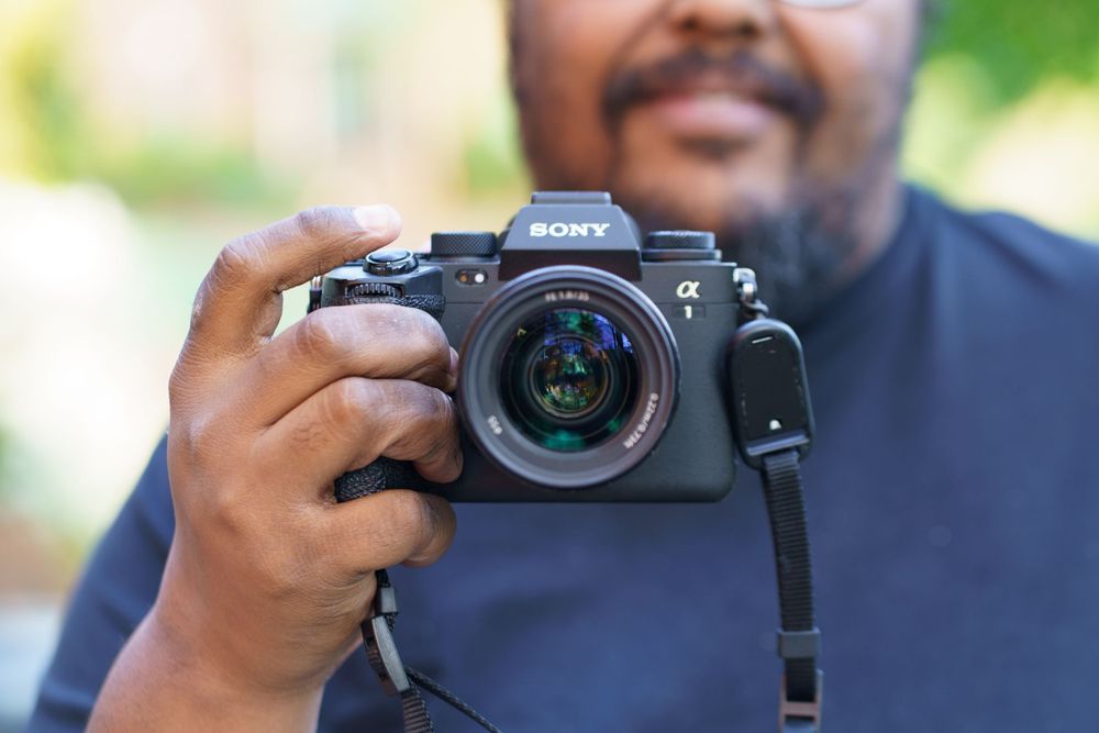 Close-up shots of someone holding and operating a Sony camera outdoors.