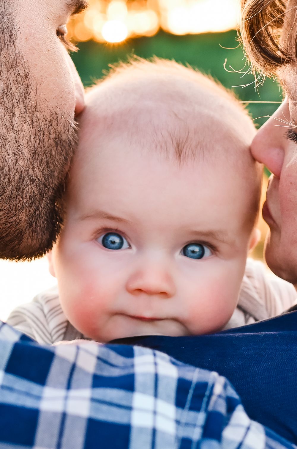 Parents kissing their baby at West Lafayette, Indiana.