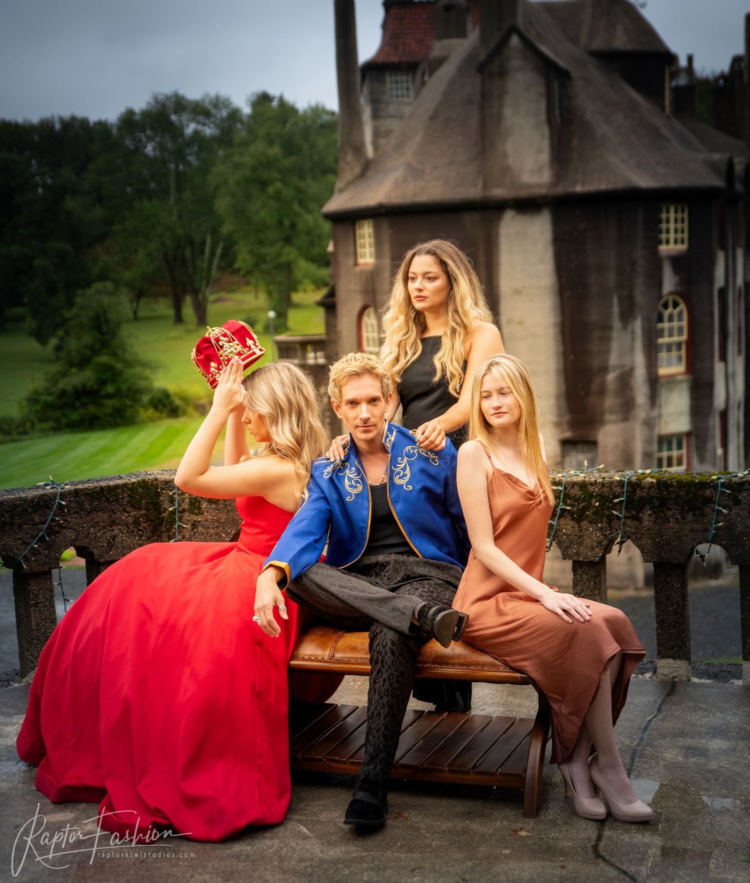Elegant outdoor photo session at a castle featuring people in formal evening wear.
