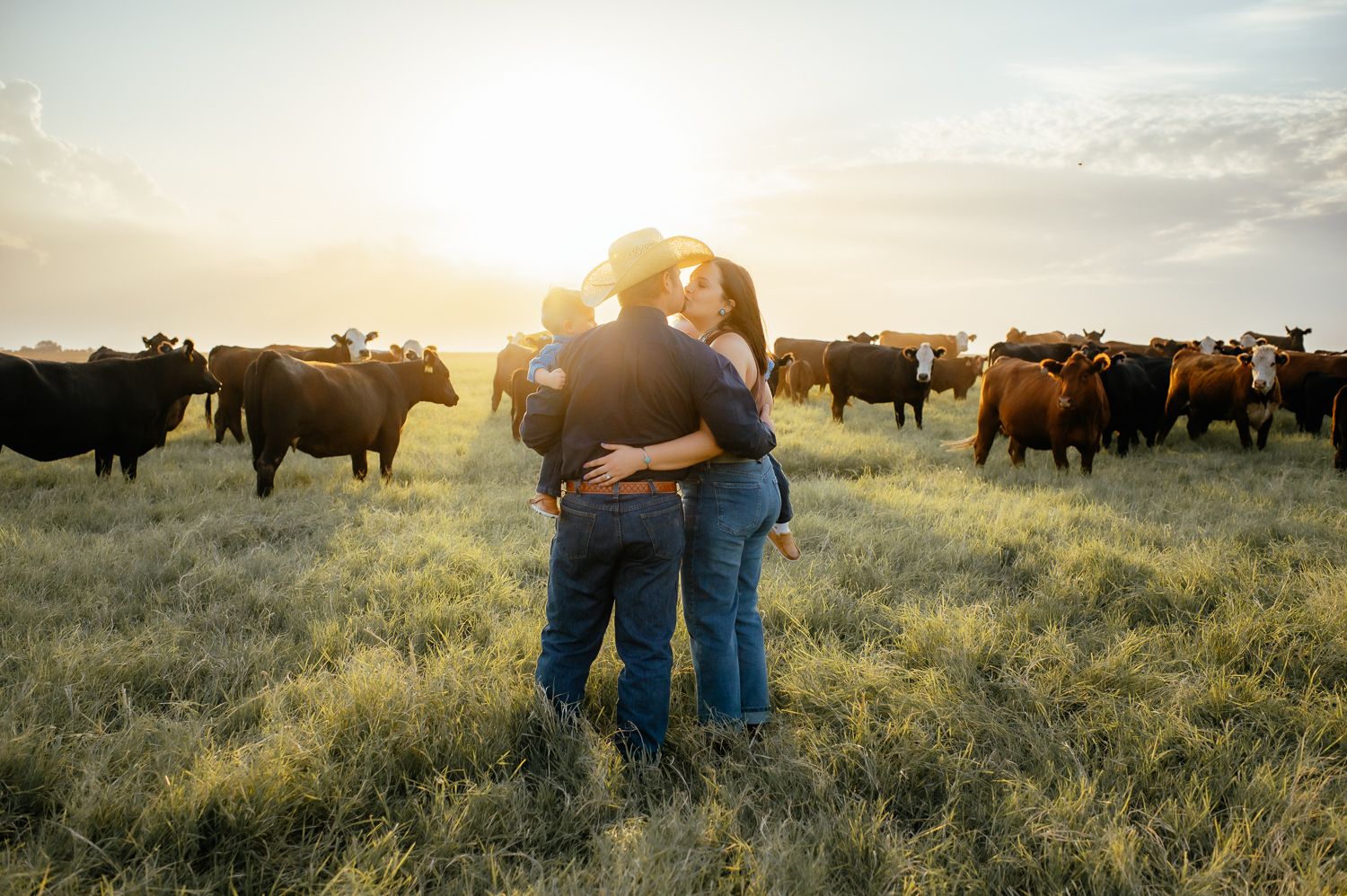 Family of four pose for a family photographer in Enid OK.