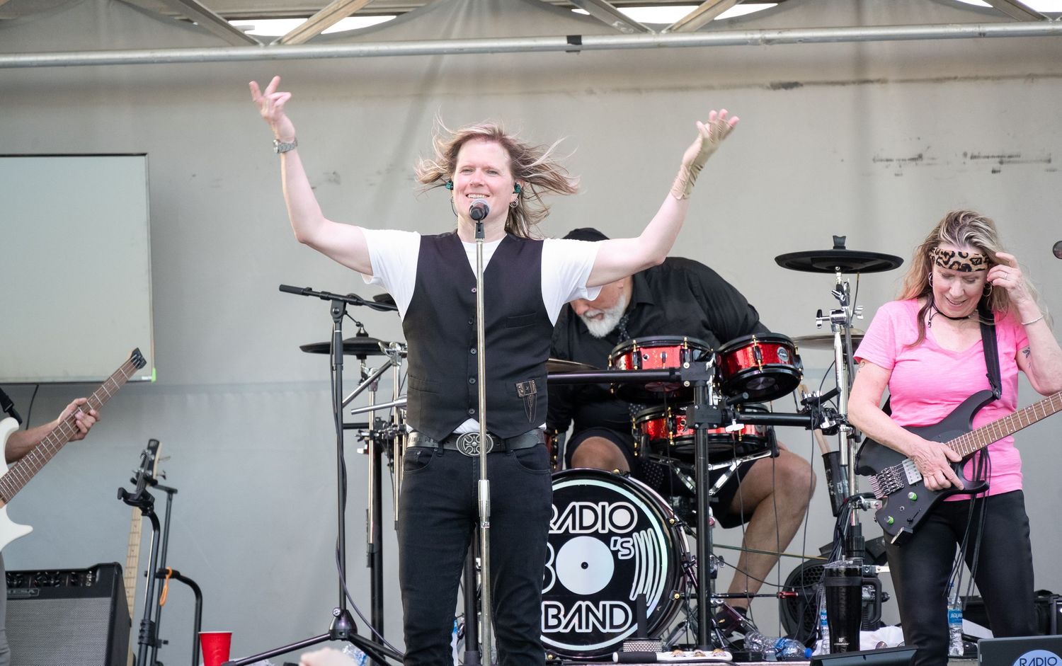 Dynamic performance on stage with band members playing various instruments.