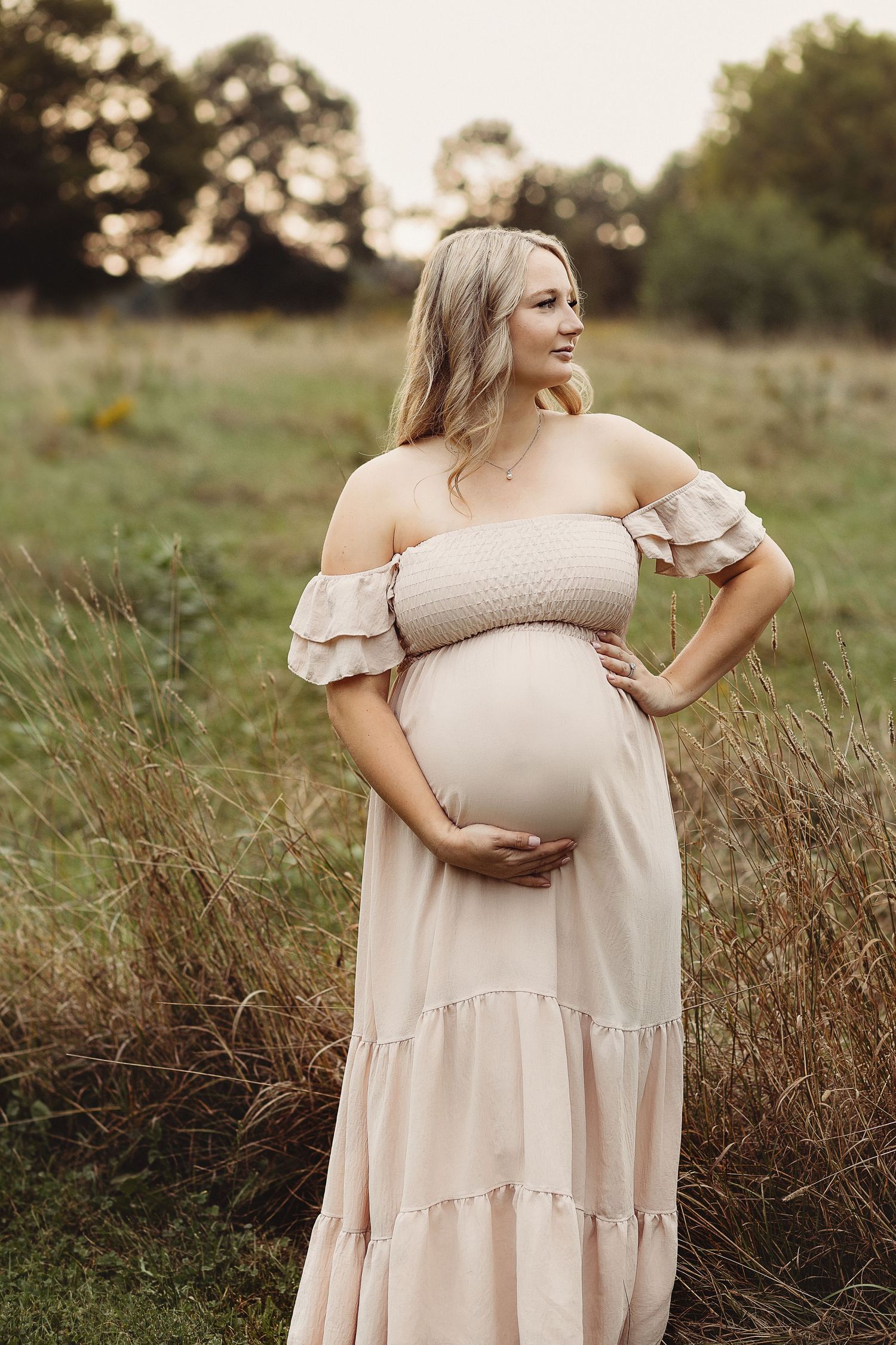 Professional maternity photos of a pregnant mother holding her belly