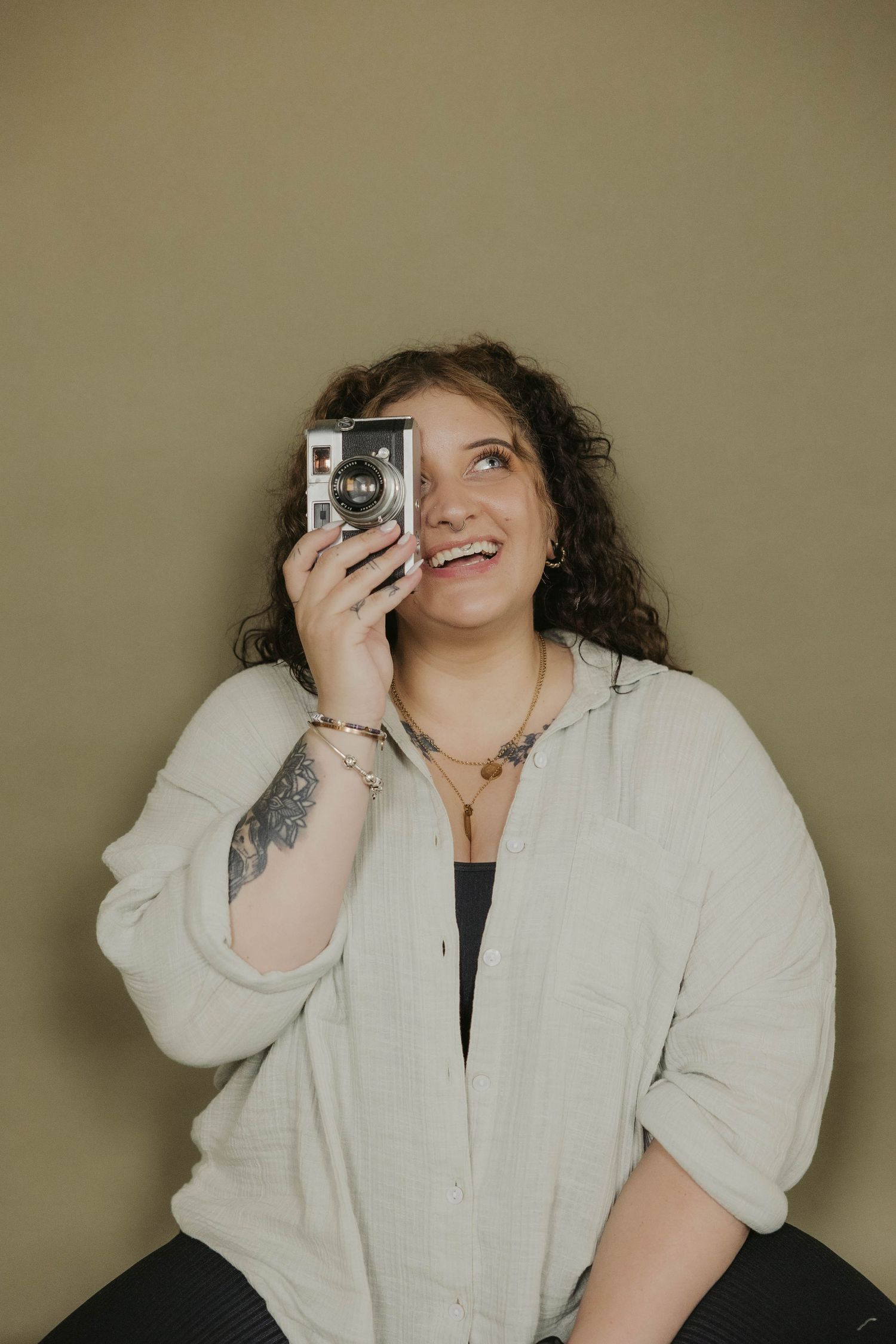 Photographer demonstrates vintage camera techniques in studio setting.