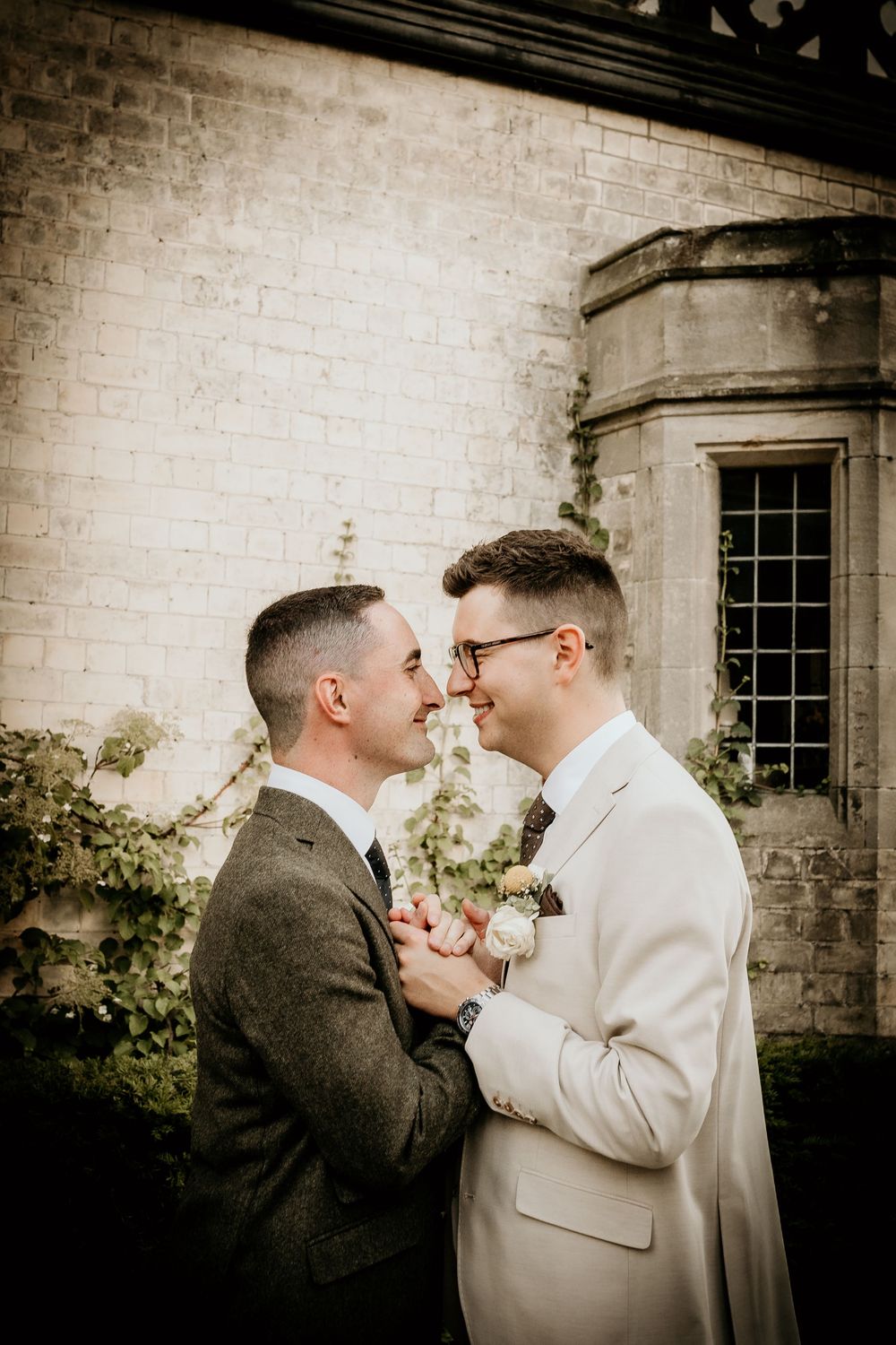 A romantic sepia-toned photo series showing a couple embracing against a brick wall with windows.