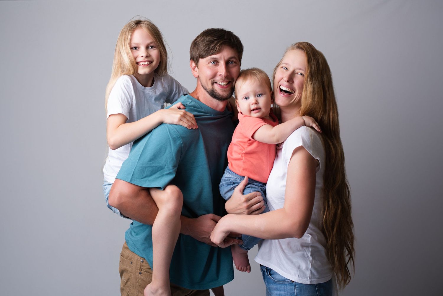 Happy laughing family of four captured by Seattle family photographer