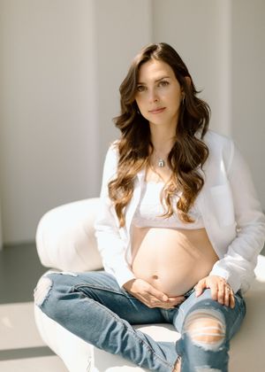 A person in a white button-down shirt and blue jeans poses casually against a neutral background in multiple shots.