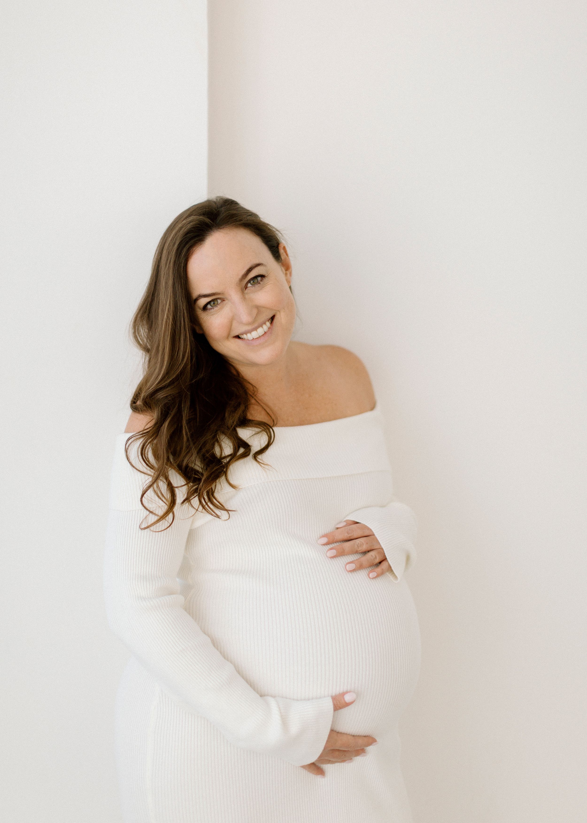 A series of four portraits showing someone in a white sweater posing playfully against a light background.