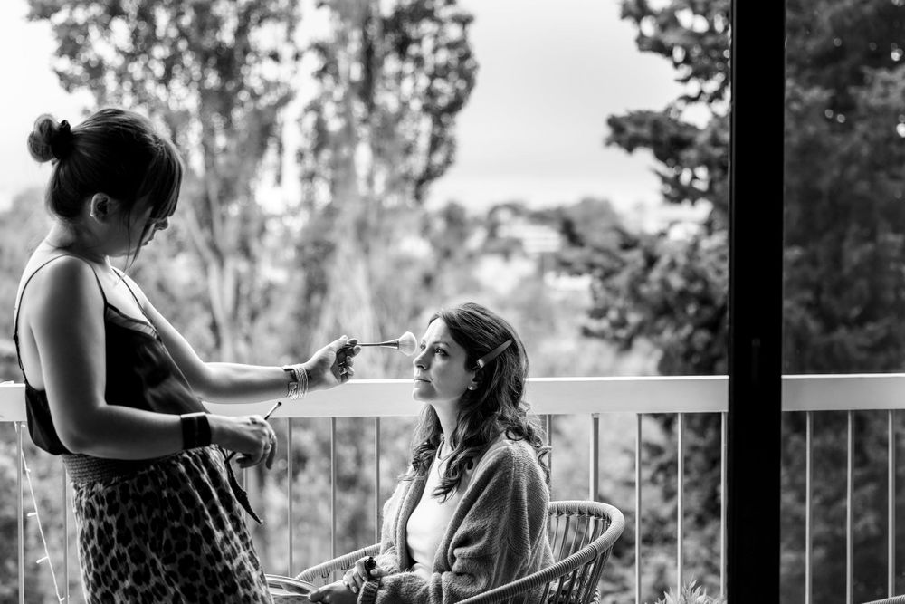 Two people having a quiet conversation together on an outdoor balcony in black and white photography.