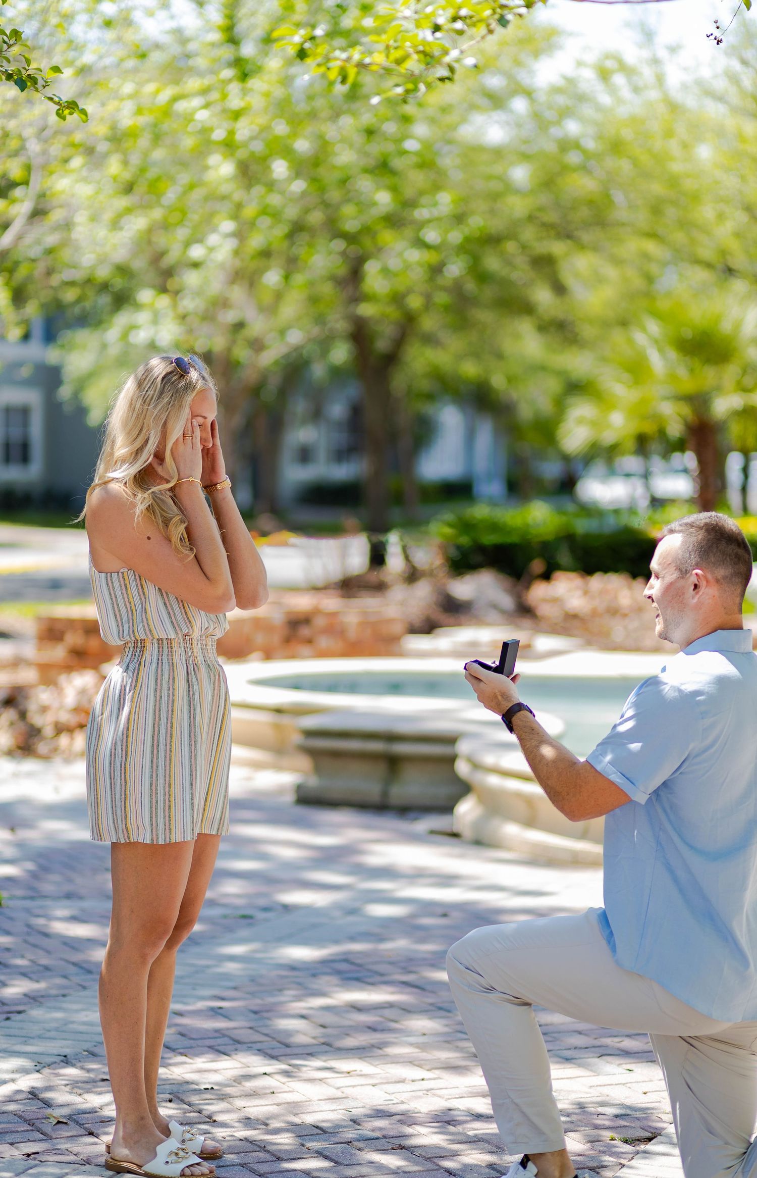 A surprise marriage proposal moment in a beautiful garden setting.